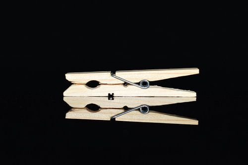 Clothes peg close-up on black background