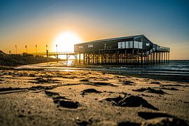 Sunset with beach club in the sea by Jan Hermsen
