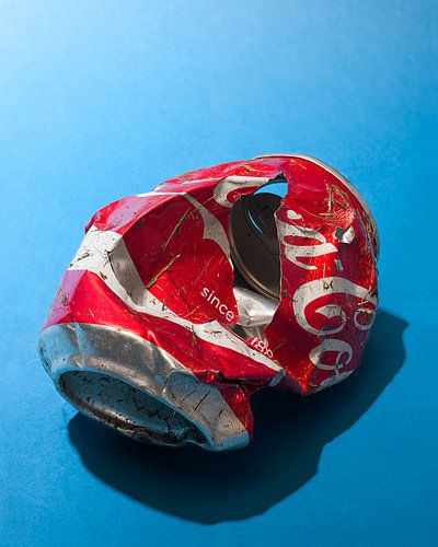 Pop art. Coca-Cola can crushed by lawn mower