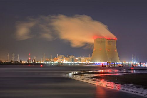 Riverbank with illuminated nuclear reactor Port of Antwerp