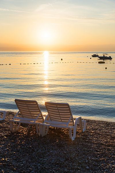 empty sunbed chairs at gravel beach moscenicka draga croatia, sunrise scenery. beautiful  ocean in s by SusaZoom