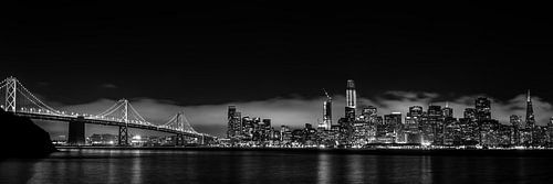Panorama shot of San Francisco skyline at night with bay bridge in black white in low key