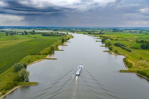 Schiff auf dem Fluss Lek mit Regenwolken darüber