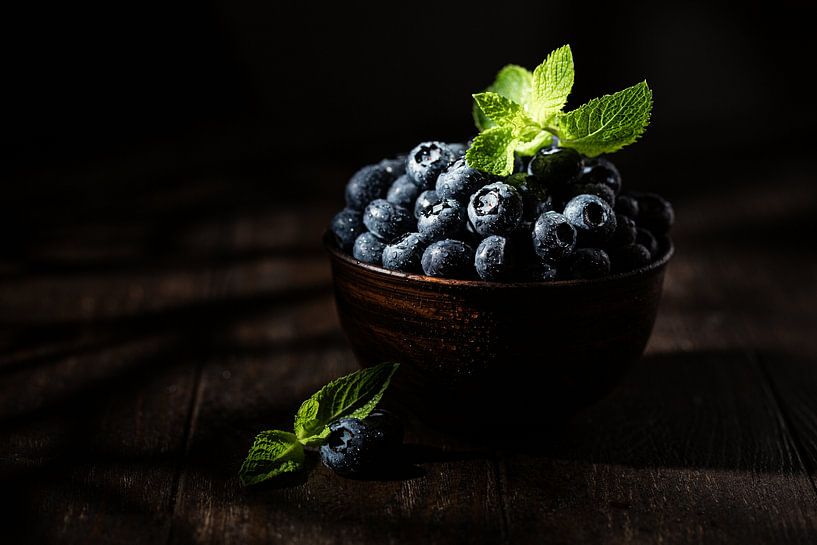 Blaubeeren mit Minzblättern in brauner Schale von Iryna Melnyk