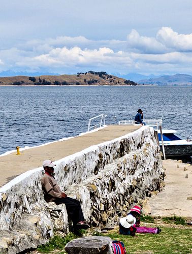 Two men and a girl at the water's edge