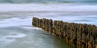 Wooden buoy in the surf