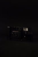 Old camera against a black background