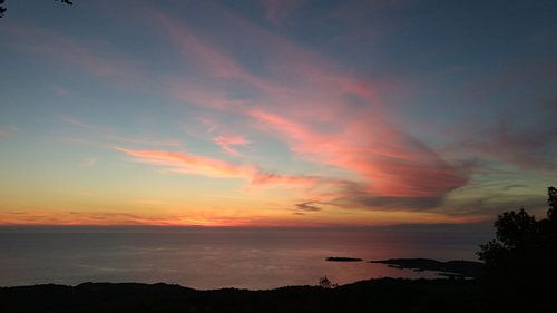 The sun is setting in the sea - orange-pink sky