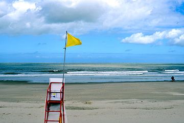 Yellow beach flag to lifeguard chair by Lilly Wonderz