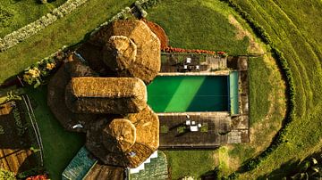 Traditional house with thatched roof and swimming pool in Philippines by Surreal Media