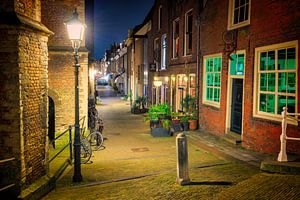 The Kerkstraat in Delft by night, next to the famous Nieuwe Kerk of Delft. by Bas Meelker