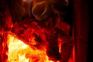 Glühende Glut mit orange-roten Flammen brennenden Holzes