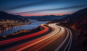 Zeitraffer-Autolichtspuren auf der nächtlichen Straße am Meer
