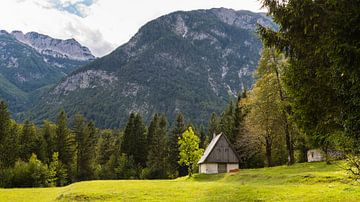 Mountain hut in front of high mountains in Slovenia by Robert Ruidl