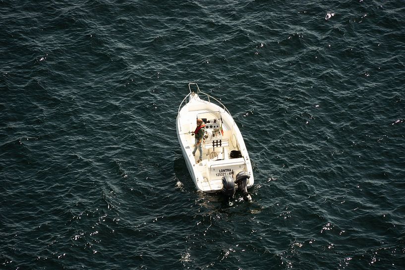 Fisherman alone in the sea by Stef Wingens