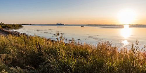 Ferry on the Schaproder Bodden in the evening light by Werner Dieterich