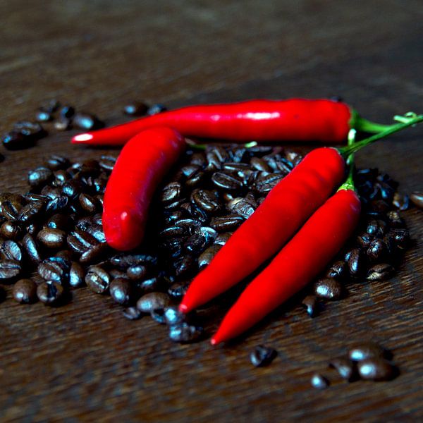 Fresh coffee beans and red hot chilli pepper by Silva Wischeropp