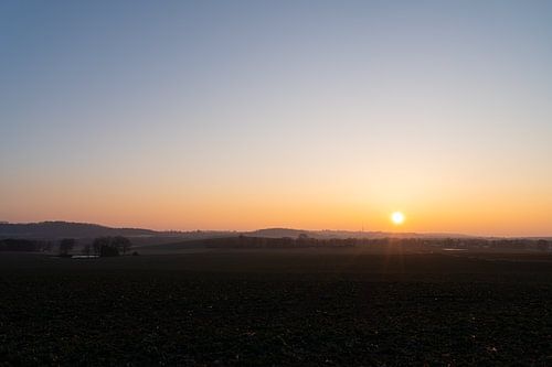 Serene sunset over rolling hills