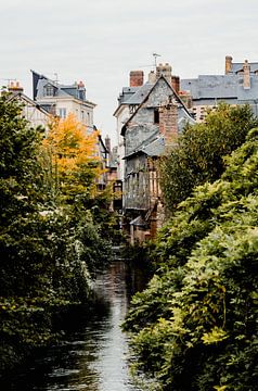 old houses along a river in France by Karen Velleman