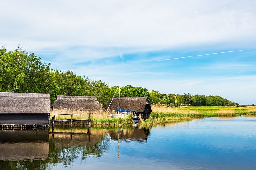 Landscape with boathouses on a lake by Rico Ködder