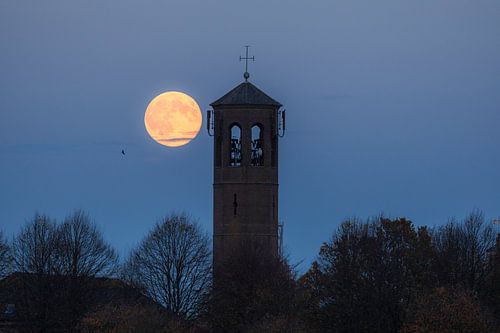 Full moon at church tower in Heusden