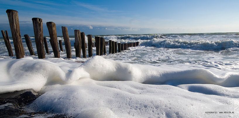 Schuim tegen strandpalen panorama van Peter van Heulen