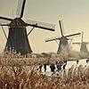Ice skating in front of the windmills of Kinderdijk by Frans Lemmens