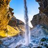 Behind the waterfall Kvernufoss by Sander Peters