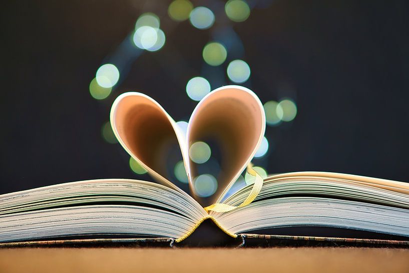 Heart pages in a book with light dots by Martin Köbsch