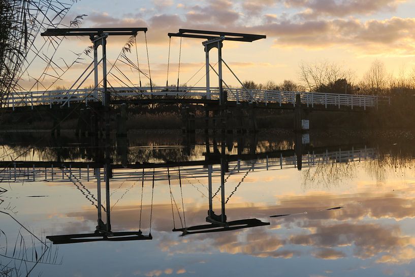 Reflection of a dutch bridge around sunset by Denise M. Jans