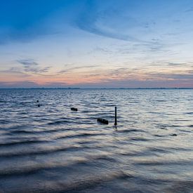 Sonnenuntergang über einem See, mit sichtbarer Wasserbewegung. von Jan van Broekhoven