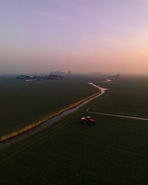 Red tractor in misty polder landscape at sunrise by Ewold Kooistra