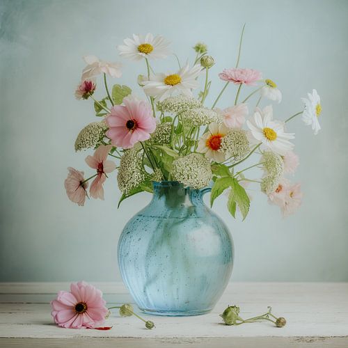 Pastel-coloured summer flowers in glass vase.