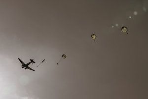 Eine Douglas C-47 Skytrain (auch bekannt als Dakota) wirft Fallschirmjäger während der Gedenkfeierli