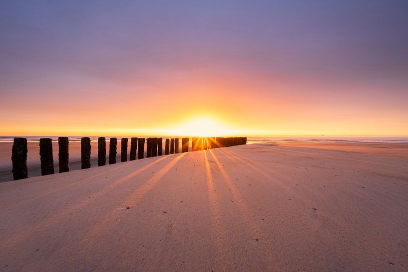 Sunshine through the breakwaters on Zeeland's beach by Jolanda de Leeuw