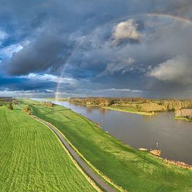 Rainbow during an autumn rain shower over the river IJssel