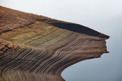 Layered land: headland touching a lake in the southern part of Armenia
