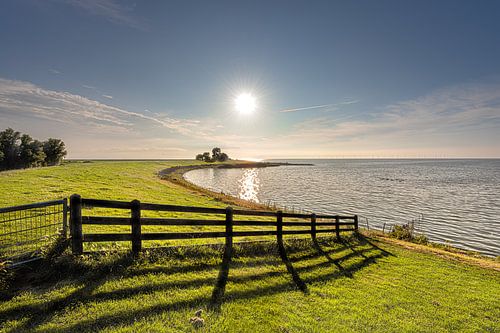 The IJsselmeer dike near the Frisian town of Molkwerum in the afternoon sun