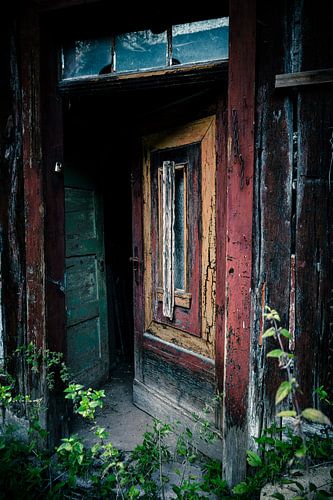 Weathered door - entrance to the past of an abandoned house