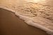ebener Sandstrand mit weißem Schaum vom Meer von Margriet Hulsker