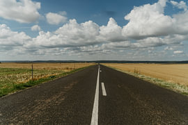 Endless Road Beneath a Dramatic Sky by Diederik De Mezel