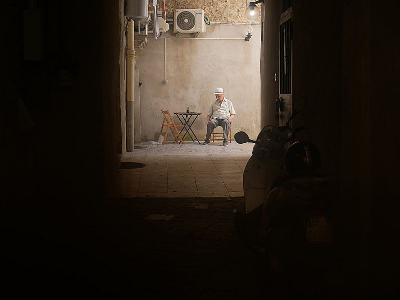 Italian senior with cactus sitting in the morning light by Marcella van Tol