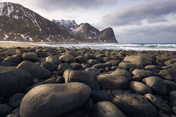 Stones and Waves at Unstad Beach Under Lofoten's Majestic Mounta