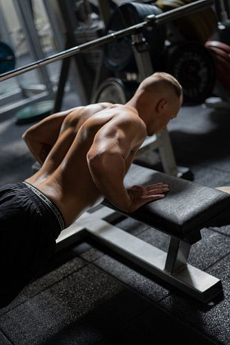 Muskulöser Mann im Fitnessstudio Farbe