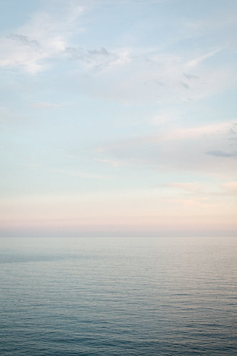 A calm sea and a gentle horizon in pastel colours