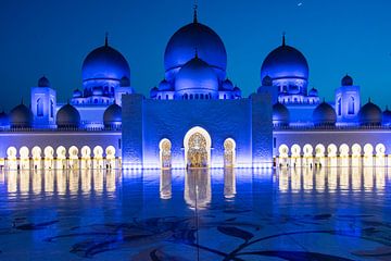 View of the blue-lit Sheikh Zayed Grand Mosque in the evening in Abu Dhabi, United Arab EmiratesSigh by WorldWidePhotoWeb