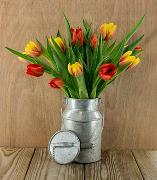 red and yellow tulips on wood