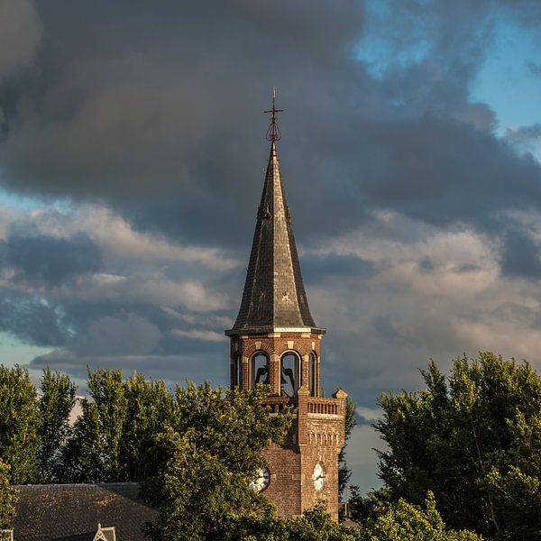 The church tower of the Frisian dyke village of Zurich in the evening light by Harrie Muis