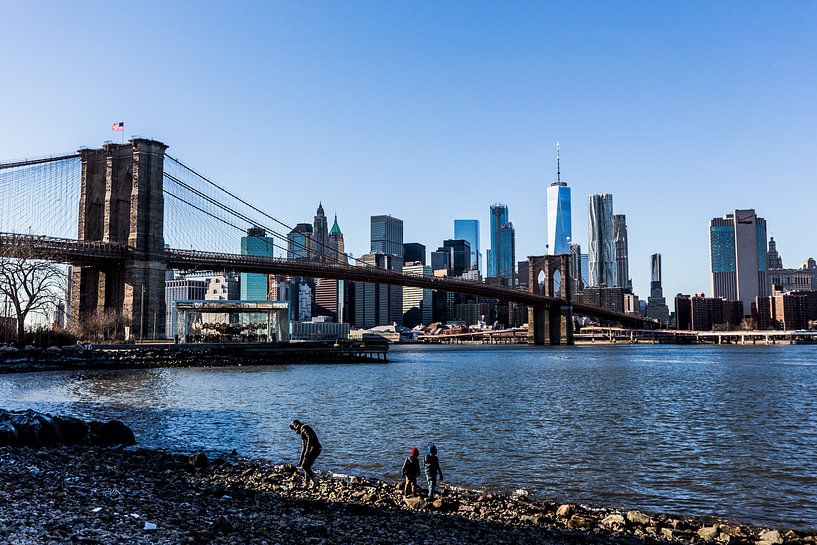 one world trade center and brooklyn bridge in New York in the winter by Eric van Nieuwland