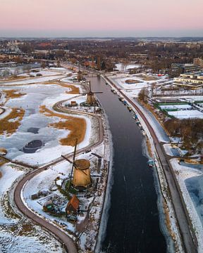 Winter windmills along the Alkmaar canal by Ewold Kooistra